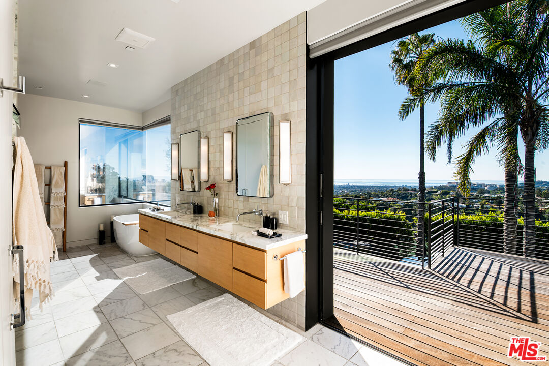 1030 Somera Road Los Angeles, CA 90077 - Photo 33 of 54 a large white kitchen with a large window and refrigerator