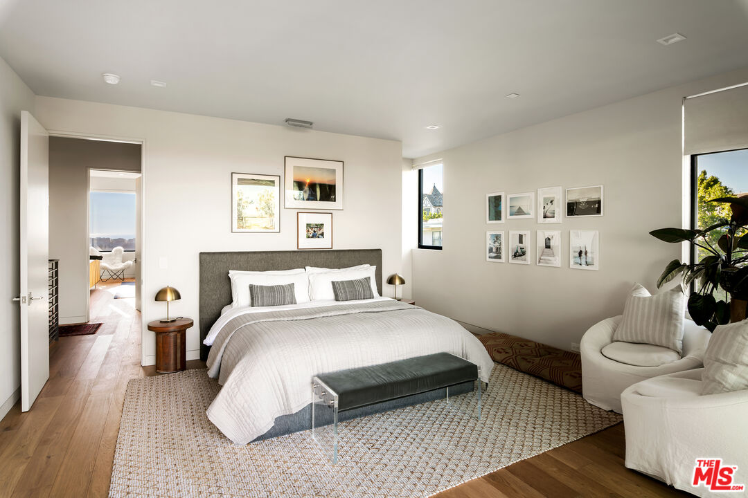 1030 Somera Road Los Angeles, CA 90077 - Photo 37 of 54 a bedroom with a bed and wooden floor