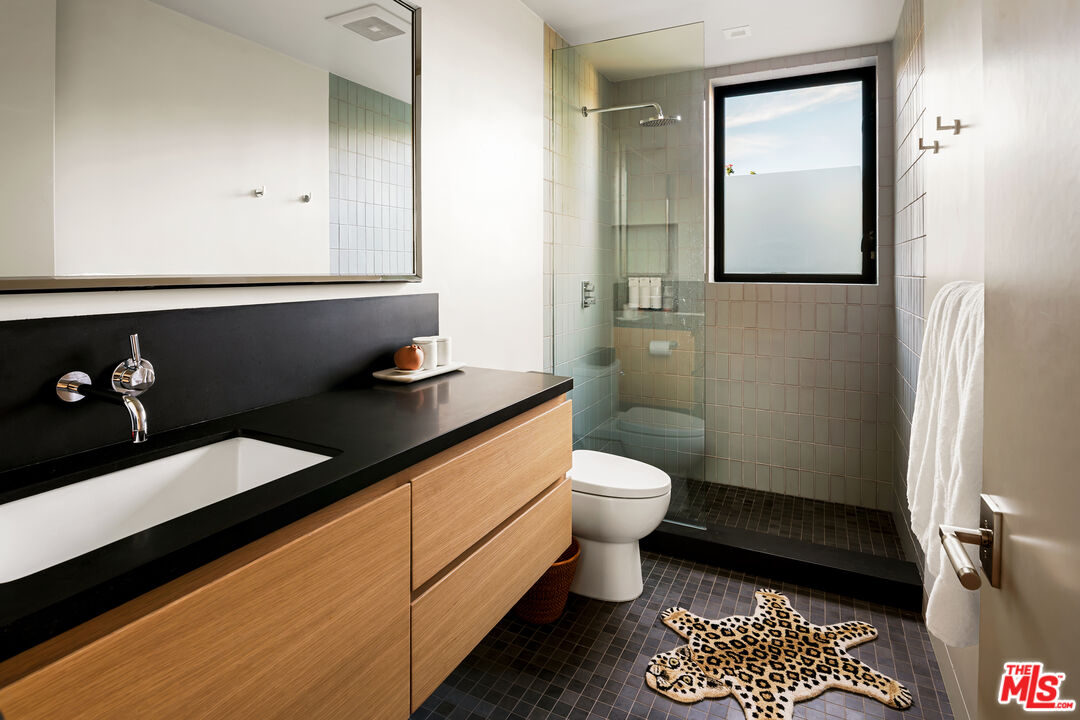 1030 Somera Road Los Angeles, CA 90077 - Photo 42 of 54 a bathroom with a toilet a sink and mirror
