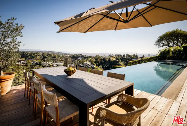a balcony with table and chairs