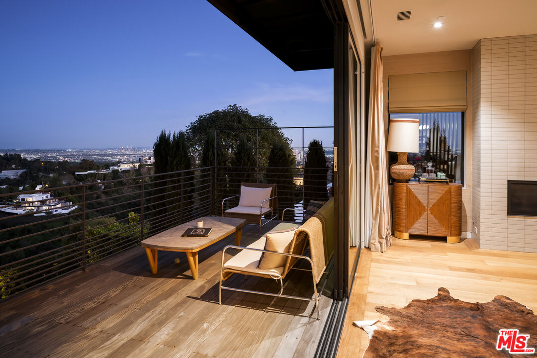 1030 Somera Road Los Angeles, CA 90077 - Photo 51 of 54 a balcony with table and chairs