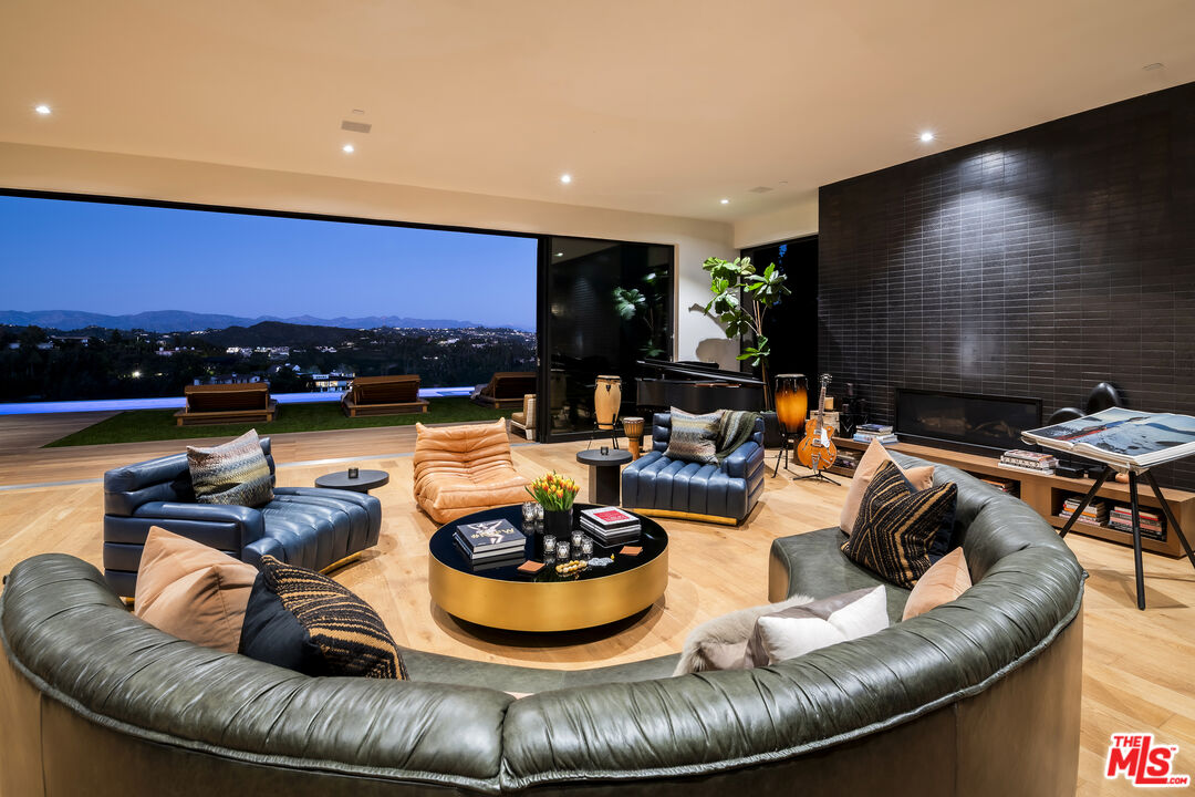 1030 Somera Road Los Angeles, CA 90077 - Photo 52 of 54 a living room with furniture and a flat screen tv