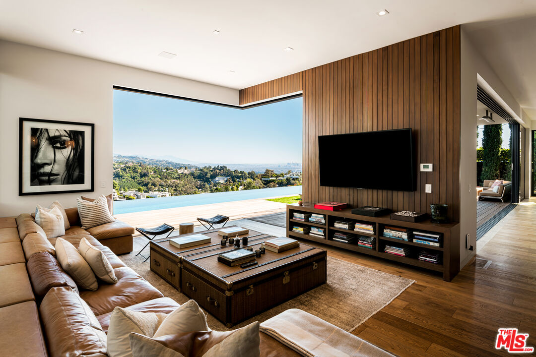 1030 Somera Road Los Angeles, CA 90077 - Photo 9 of 54 a living room with furniture and a flat screen tv