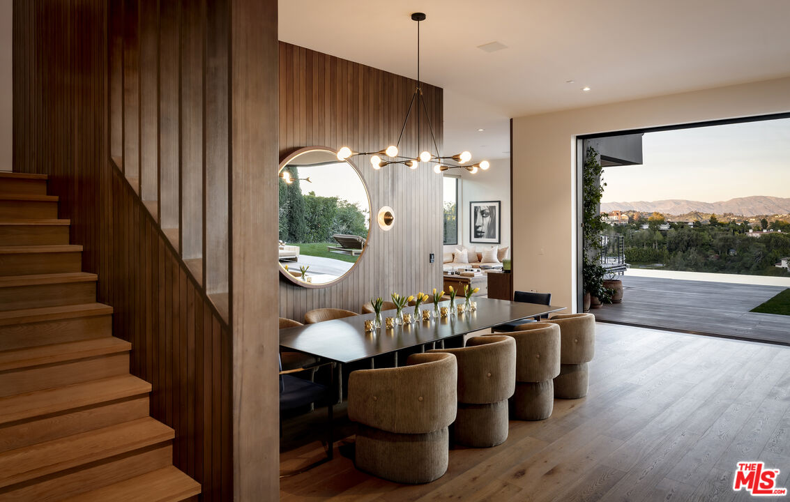 1030 Somera Road Los Angeles, CA 90077 - Photo 10 of 54 a dining room with furniture a chandelier and wooden floor
