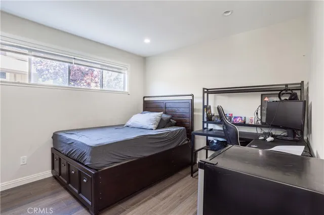 a bed sitting in a bedroom next to a window