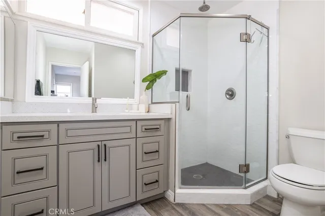 a bathroom with a granite countertop sink toilet and shower