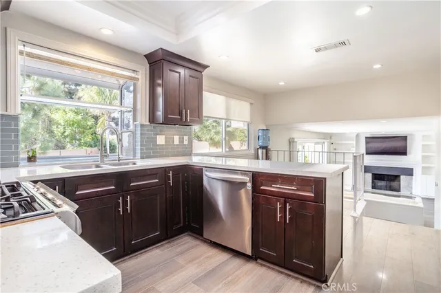 a kitchen with stainless steel appliances granite countertop a stove a sink and a microwave
