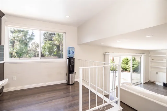 a view of a room with wooden floor and door