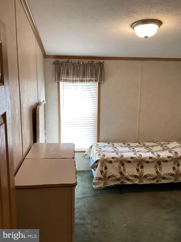 a bedroom with bed and window