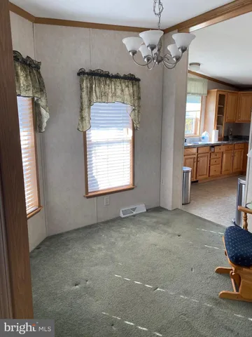 a view of a livingroom with a window and furniture