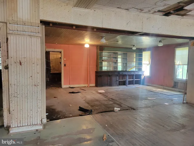 a view of a room with wooden floor and stairs
