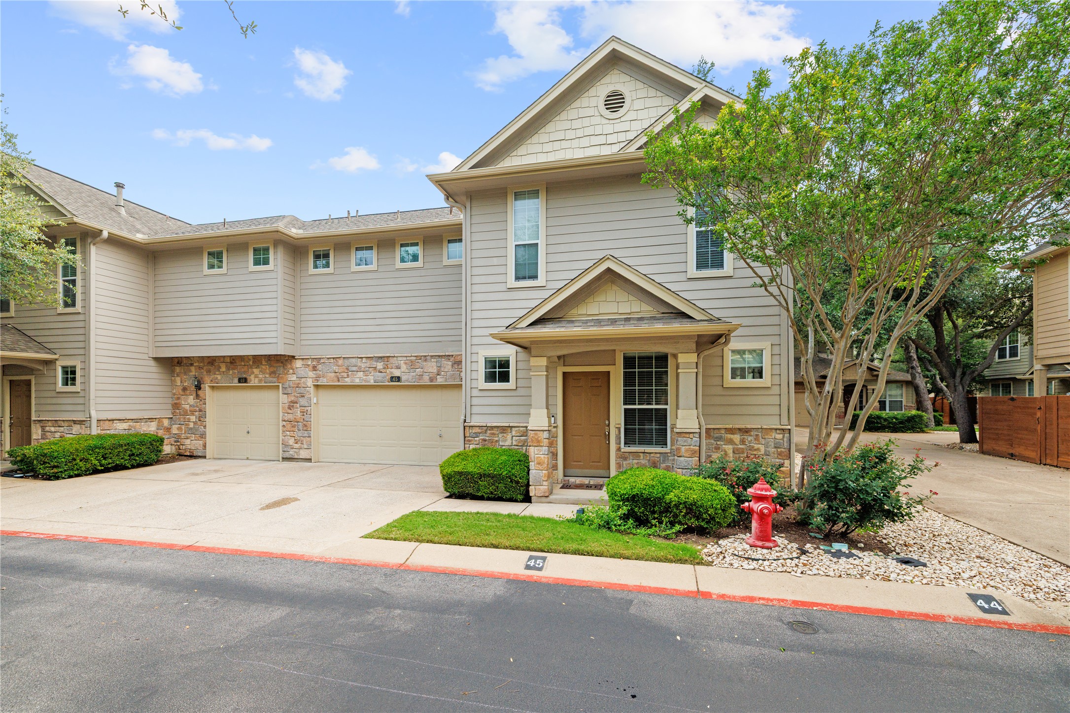 11000 Anderson Mill Road, Unit 45 Austin, TX 78750 - Photo 1 of 32 a front view of a house with a yard and potted plants