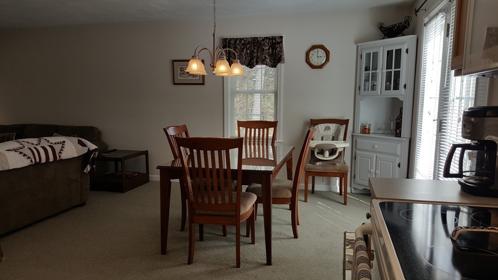 5 Hazen Road Shirley, MA 01464 - Photo 11 of 23 a view of a dining room with furniture and a book shelf