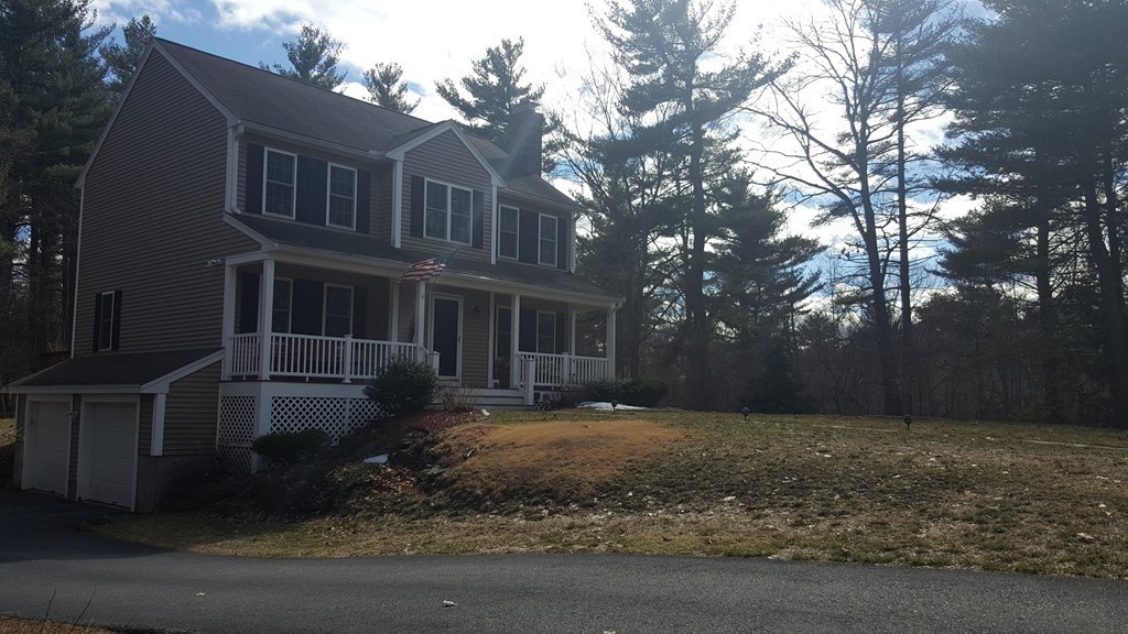 5 Hazen Road Shirley, MA 01464 - Photo 21 of 23 a view of a brick house next to a yard with large trees