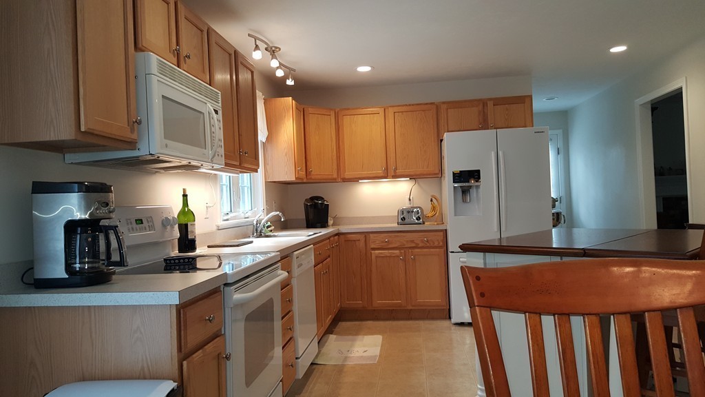 5 Hazen Road Shirley, MA 01464 - Photo 3 of 23 a kitchen with stainless steel appliances granite countertop a refrigerator and a stove top oven