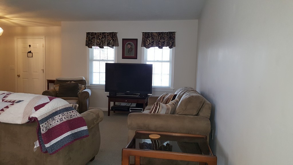 5 Hazen Road Shirley, MA 01464 - Photo 8 of 23 a living room with furniture and a flat screen tv