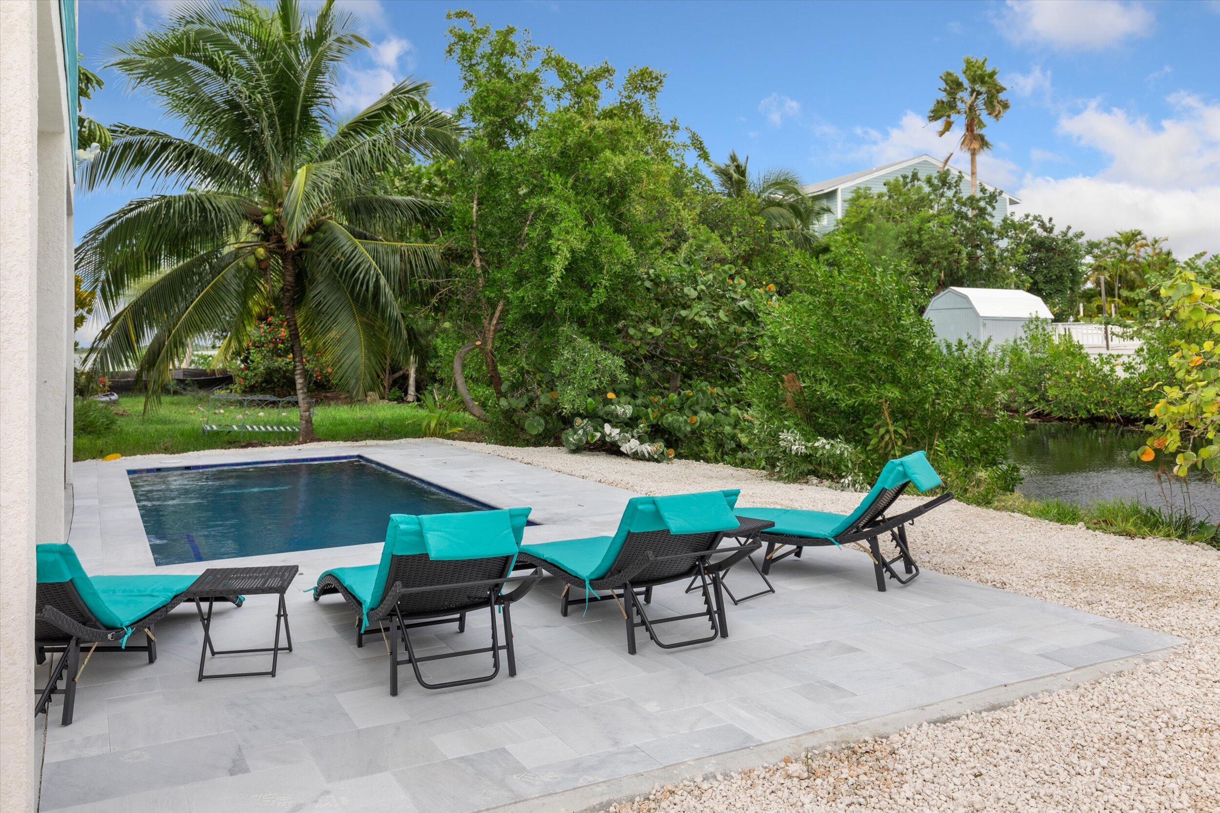 463 Les Rohde Drive Summerland Key, FL 33042 - Photo 7 of 29 a backyard of a house with table and chairs