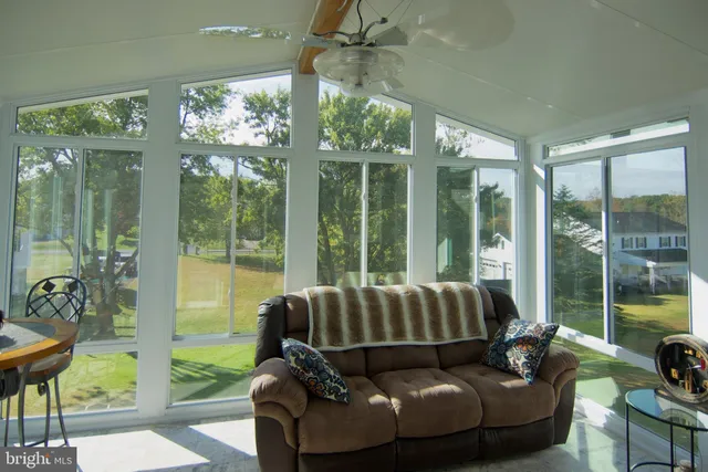 a blue chair sitting in front of a glass door