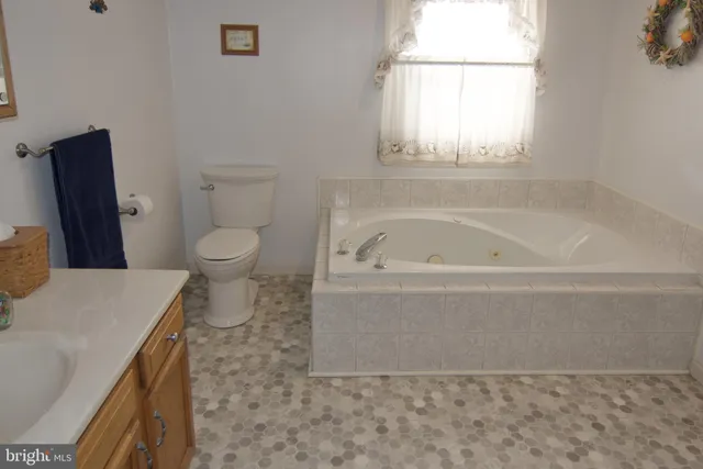 a spacious bathroom with a bathtub and toilet