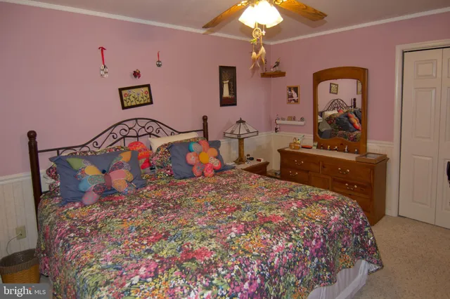 a bedroom with a bed and a painting on the wall