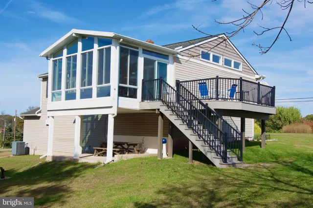 a front view of a house with a big yard