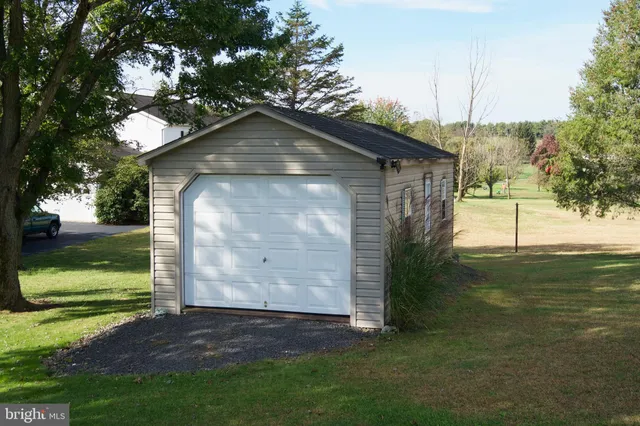 a aerial view of a house with a yard and lake view