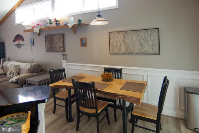 a view of a dining room with furniture and wooden floor