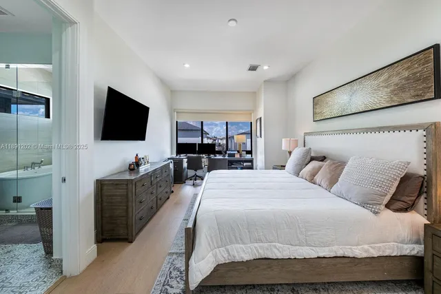 a bedroom with a bed and wooden floor