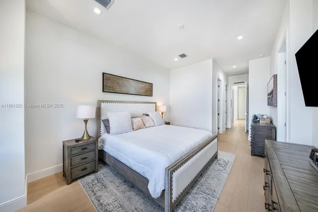 a bedroom with a bed and a night stand