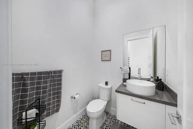 a bathroom with a sink toilet and mirror