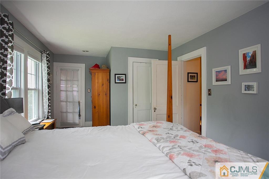 9 Lenox Street Edison, NJ 08817 - Photo 18 of 23 a bedroom with a bed and a chandelier