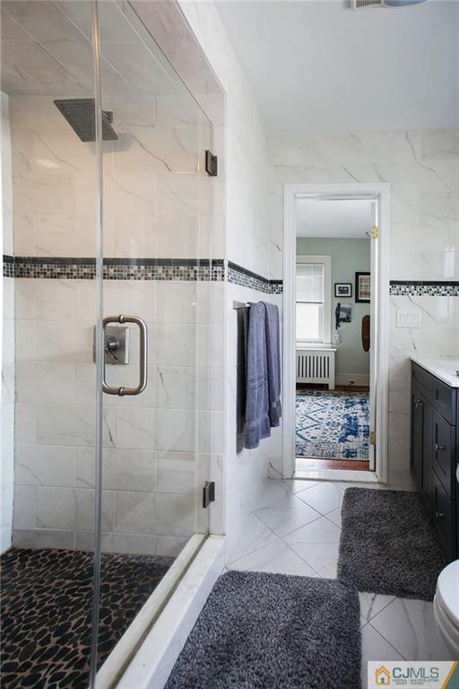 9 Lenox Street Edison, NJ 08817 - Photo 19 of 23 a bathroom with a glass door shower