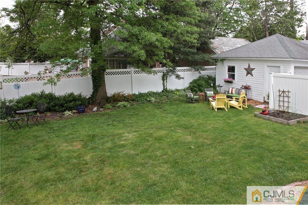 9 Lenox Street Edison, NJ 08817 - Photo 5 of 23 a backyard of a house with table and chairs plants and large tree
