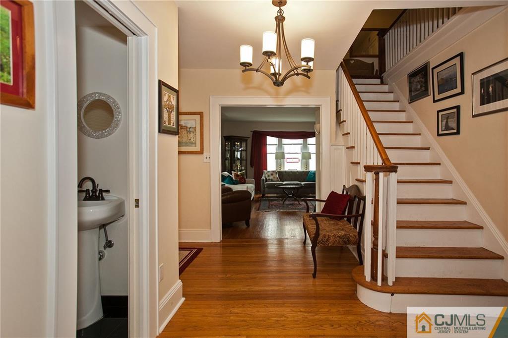 9 Lenox Street Edison, NJ 08817 - Photo 7 of 23 a view of a livingroom with wooden floor and stairs
