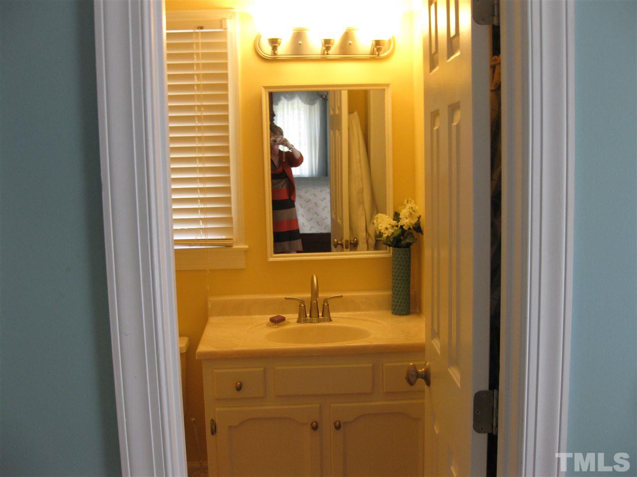 6523 Wynbrook Way Raleigh, NC 27612 - Photo 13 of 21 a bathroom with a sink and a mirror