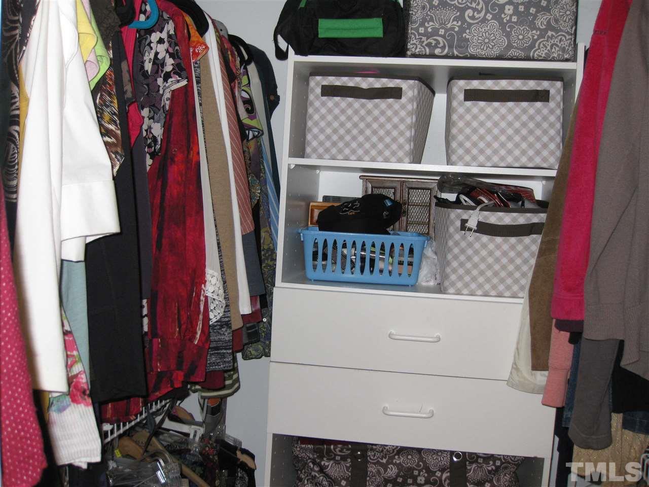 6523 Wynbrook Way Raleigh, NC 27612 - Photo 14 of 21 a view of walk in closet with clothes and shoes