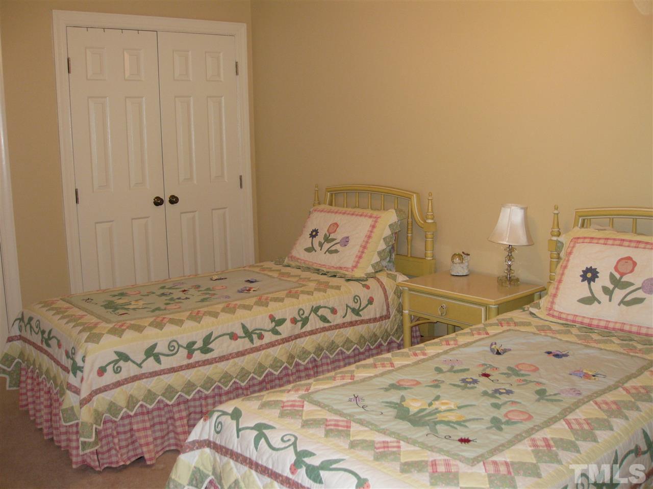 6523 Wynbrook Way Raleigh, NC 27612 - Photo 15 of 21 a bedroom with a bed and painting on the wall