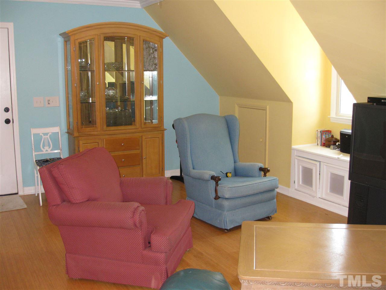 6523 Wynbrook Way Raleigh, NC 27612 - Photo 19 of 21 a living room with furniture and wooden floor
