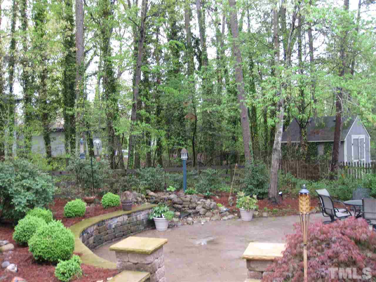 6523 Wynbrook Way Raleigh, NC 27612 - Photo 20 of 21 a view of a backyard with plants and a patio