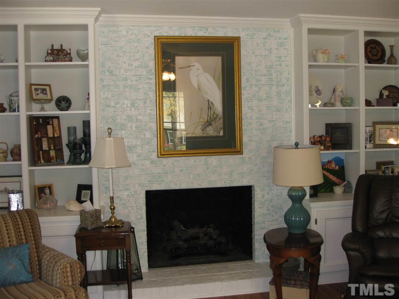 6523 Wynbrook Way Raleigh, NC 27612 - Photo 4 of 21 a living room with furniture and a fireplace