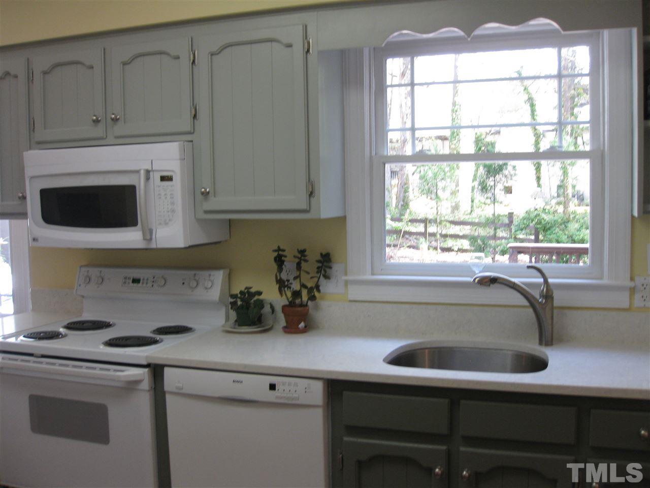 6523 Wynbrook Way Raleigh, NC 27612 - Photo 6 of 21 a kitchen with cabinets appliances a sink and a window