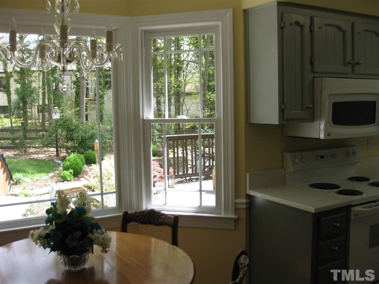 6523 Wynbrook Way Raleigh, NC 27612 - Photo 7 of 21 a living room with furniture and a floor to ceiling window