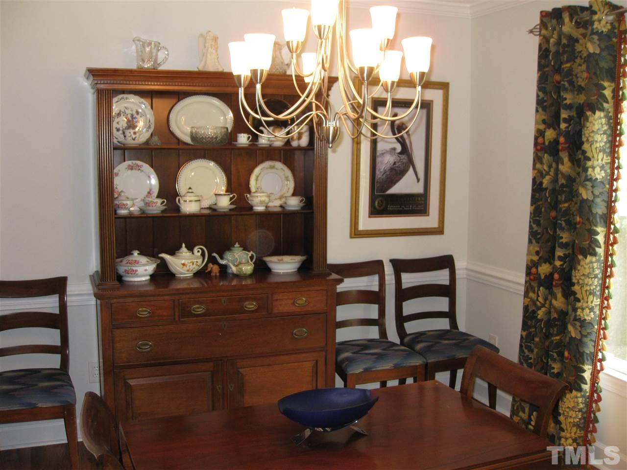 6523 Wynbrook Way Raleigh, NC 27612 - Photo 9 of 21 a table with wine bottles and glasses on it