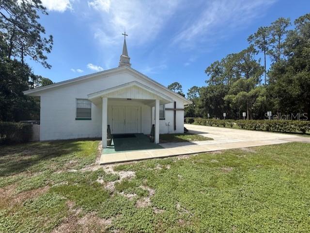 8826 Trevarthon Road Orlando, FL 32817 - Photo 1 of 57 a view of a house with backyard and trees