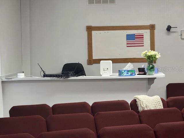 8826 Trevarthon Road Orlando, FL 32817 - Photo 11 of 57 a blue couch sitting on top of a shelf with a book shelf