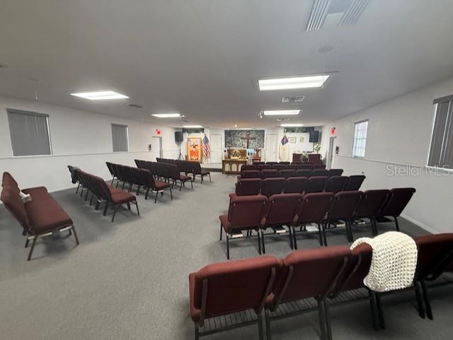 8826 Trevarthon Road Orlando, FL 32817 - Photo 15 of 57 a living room with lots of furniture and a dining table with kitchen view