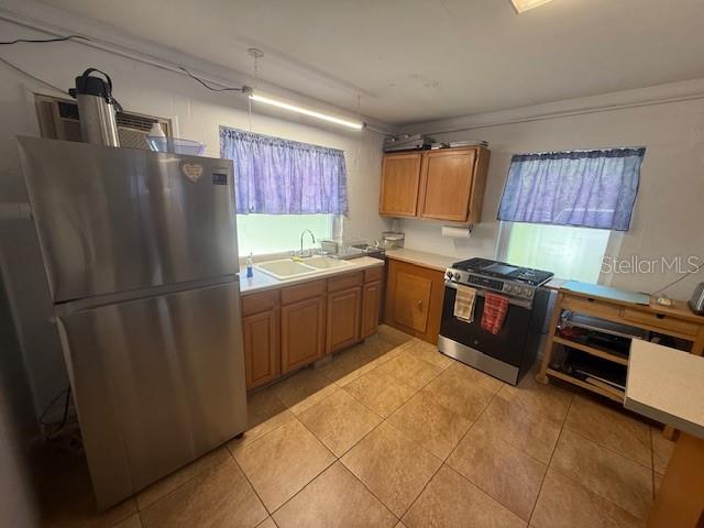 8826 Trevarthon Road Orlando, FL 32817 - Photo 30 of 57 a kitchen with stainless steel appliances granite countertop a refrigerator a sink a stove and island