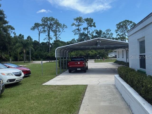 8826 Trevarthon Road Orlando, FL 32817 - Photo 35 of 57 a view of a yard with cars parked