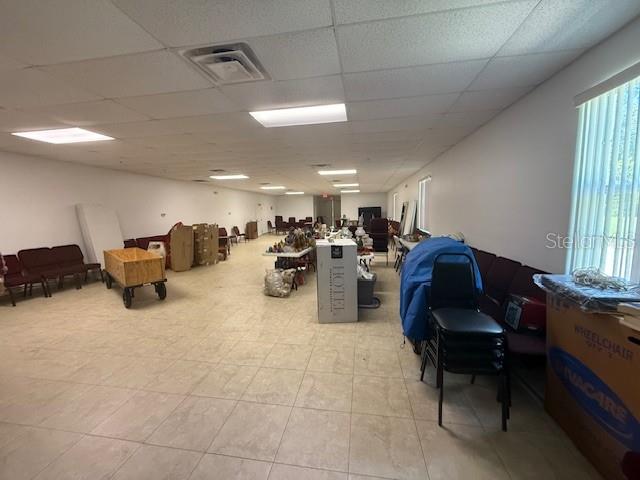 8826 Trevarthon Road Orlando, FL 32817 - Photo 52 of 57 a room with furniture and a chandelier