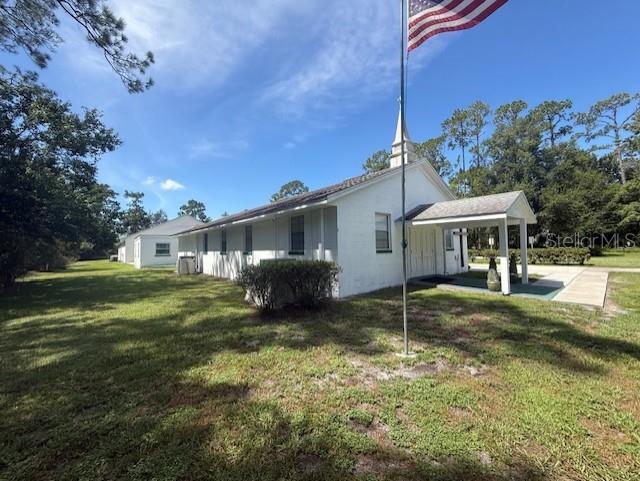 8826 Trevarthon Road Orlando, FL 32817 - Photo 6 of 57 a house view with a garden space